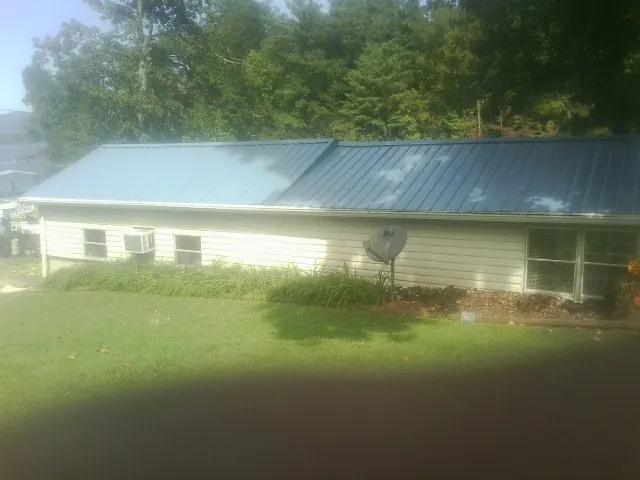 Blue metal roof running the length of a single story home in Basin